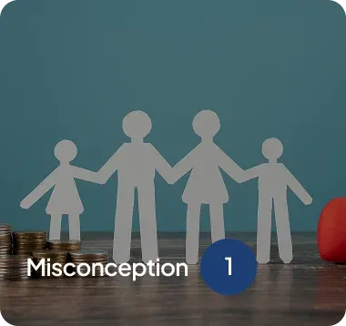 Paper cutout figures of a family holding hands on a wooden surface with coins stacked on the left and a red heart shape on the right, labeled 'Misconception 1'.
