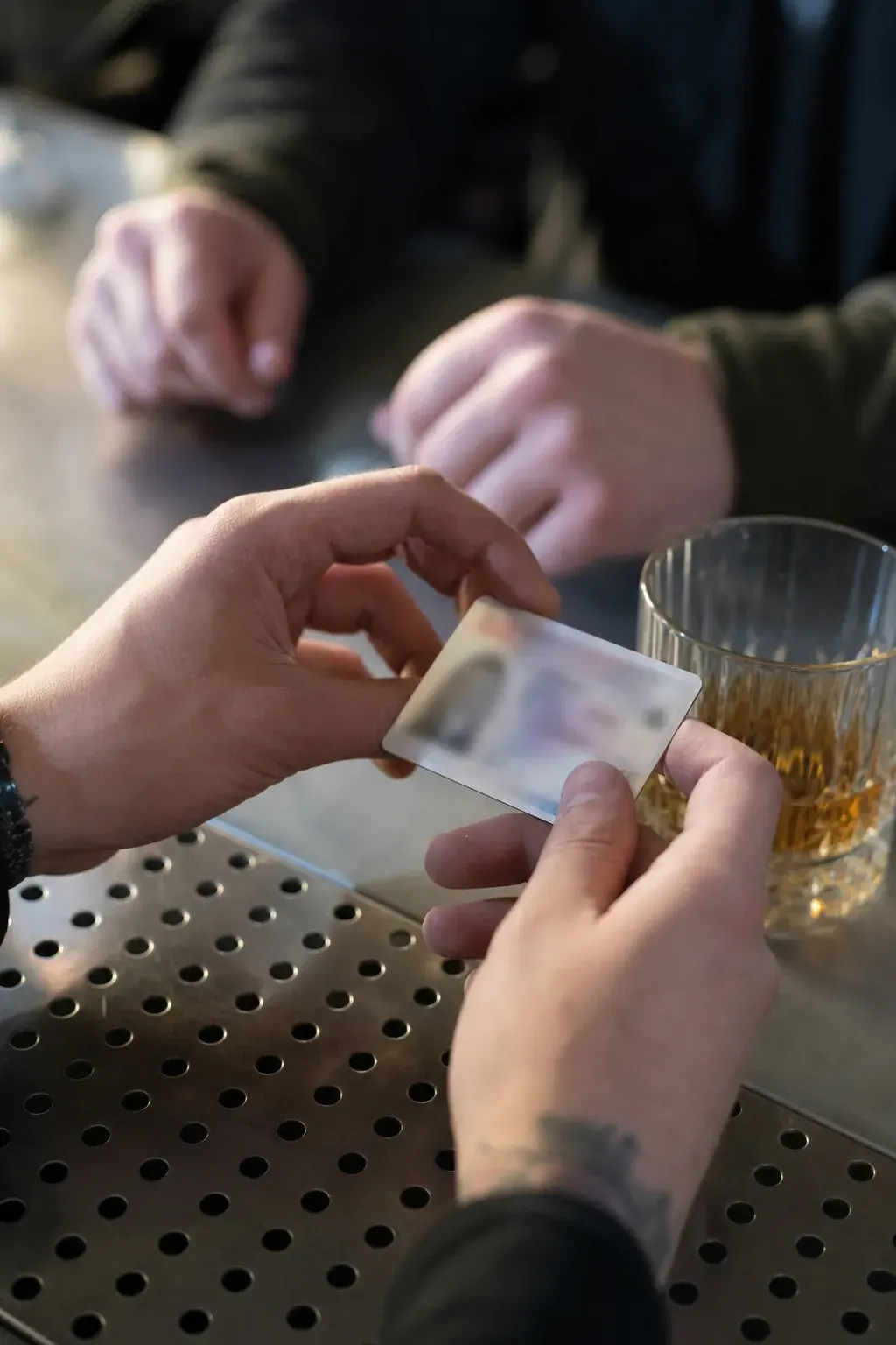 Bartender checking a customer's ID