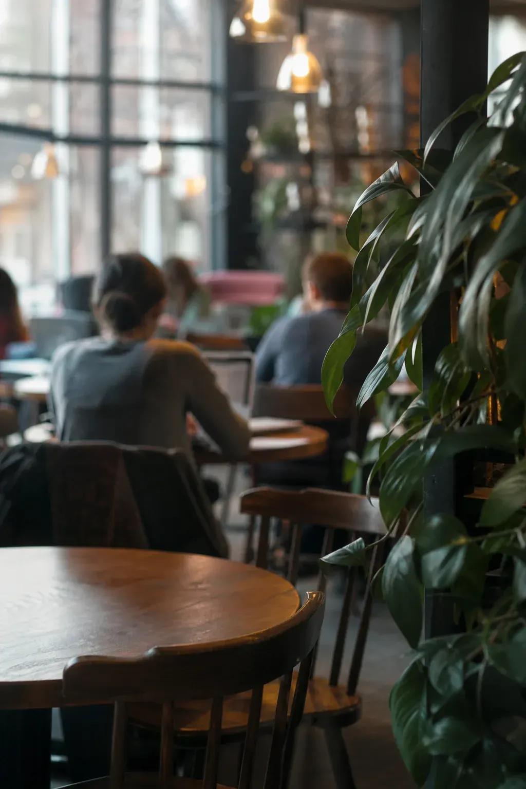 Customers working on laptops in a cafe