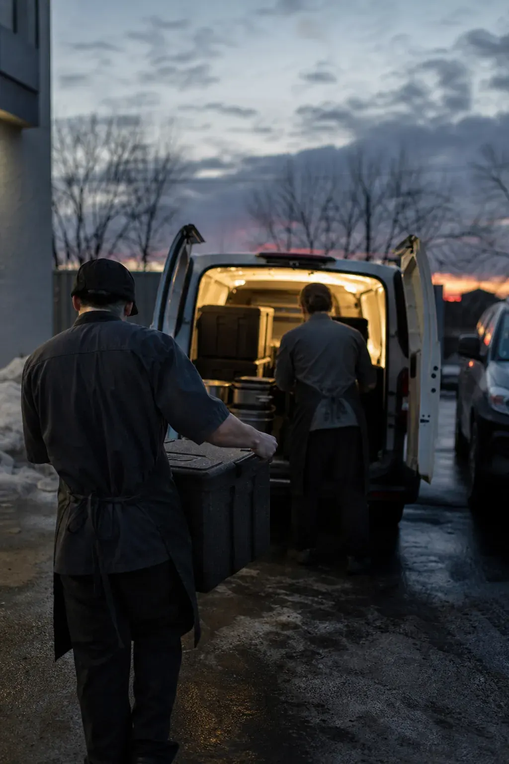 Catering staff loading a van