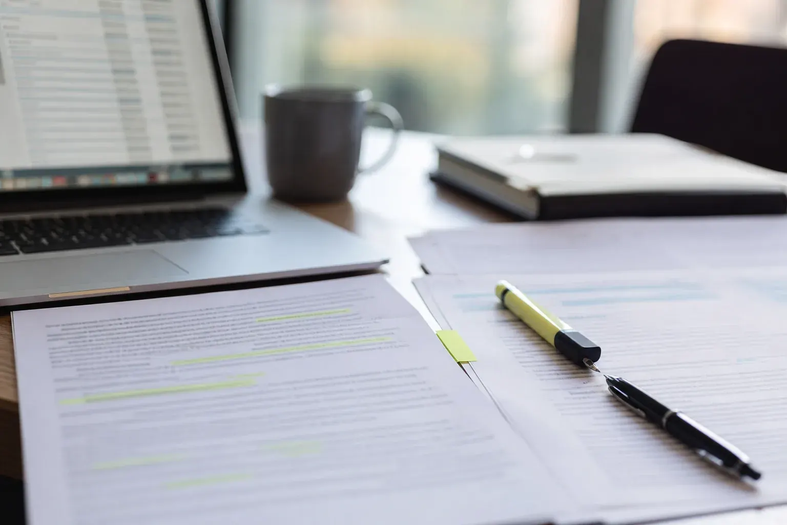 Comparing side by side insurance proposals on a desk