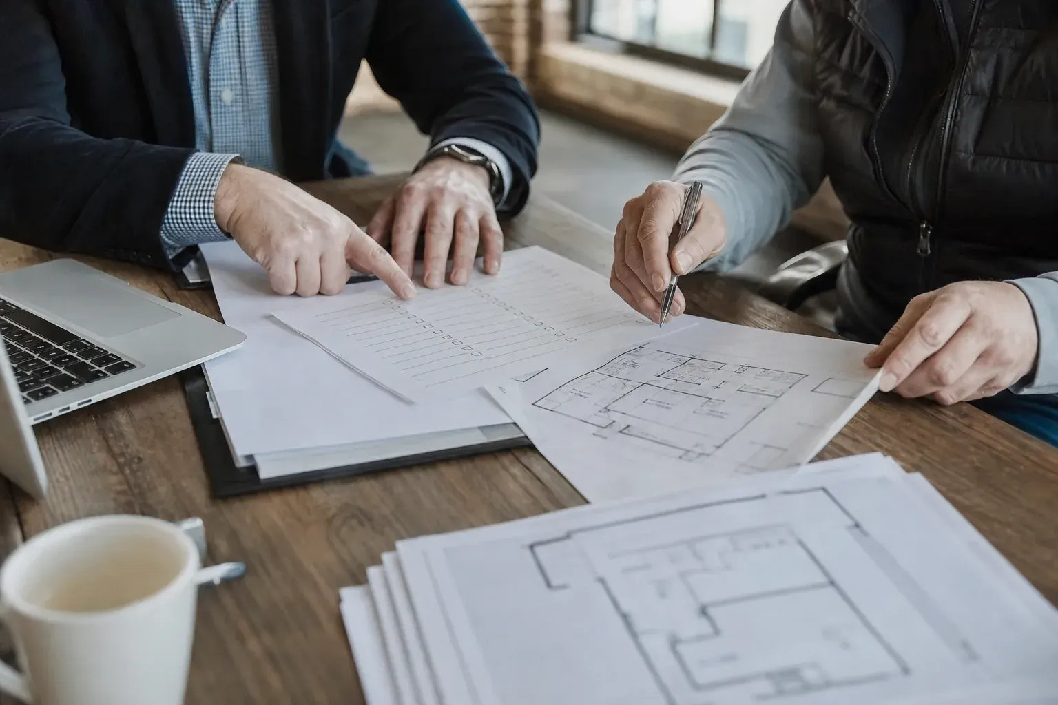 Broker and business owner reviewing a risk checklist together