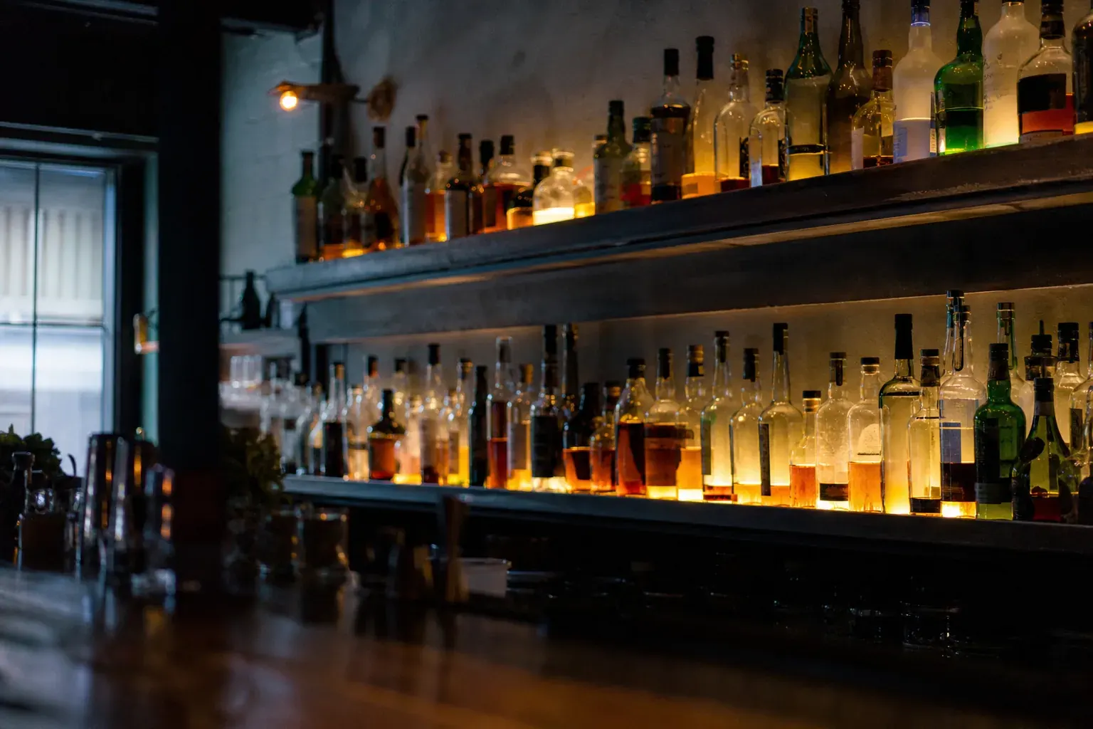 Back bar shelves lined with bottles