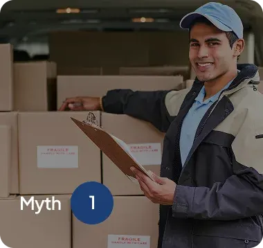 Delivery worker in uniform holding a clipboard and smiling beside stacked boxes labeled fragile.