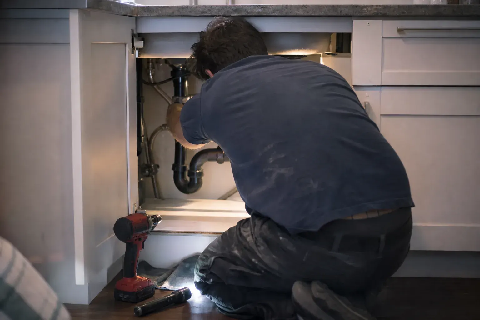 Plumber under a sink