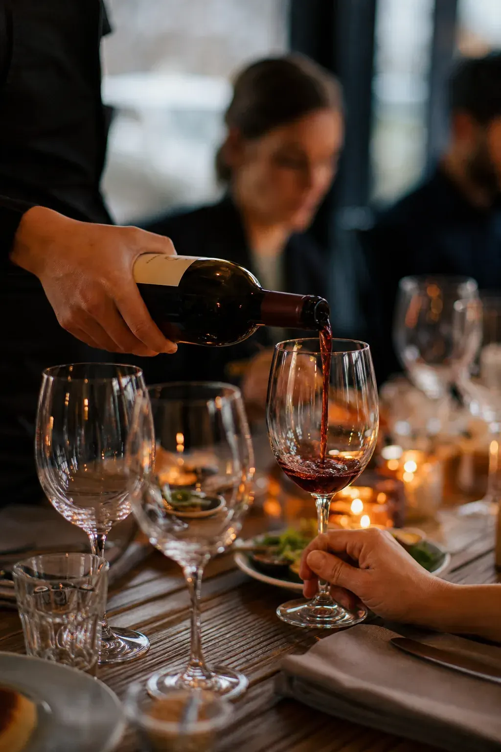 Server pouring wine for guests