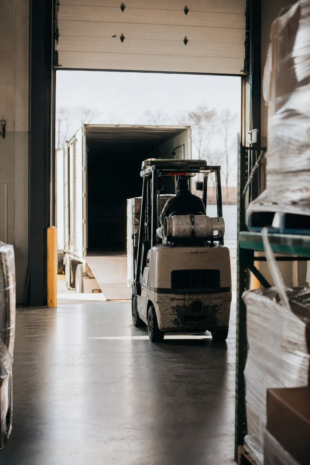 Manufacturing shipping dock with wrapped pallets and a forklift