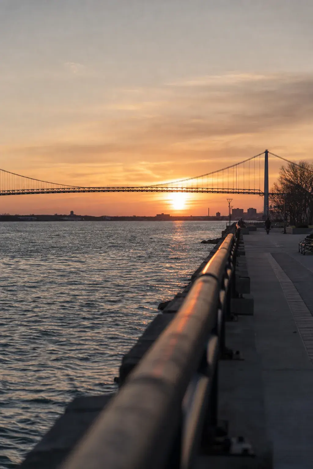 Waterfront with the Ambassador Bridge at sunset
